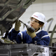 A young worker screws a bolt into the hood at a plant manufacturing car bodies at Nissan Motor Co.’s Tochigi Plant in Kaminokawa-Machi in Tochigi prefecture, north of Tokyo, Friday, June 15, 2007.